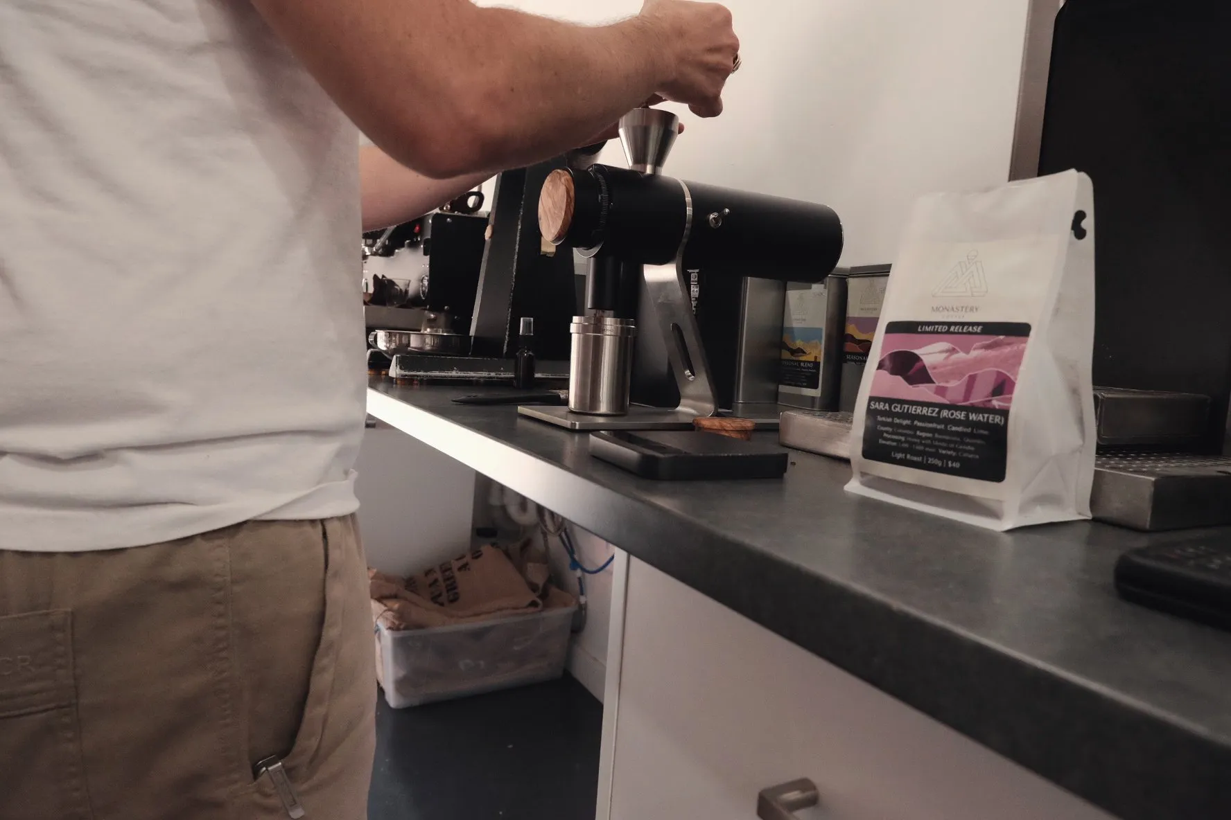 A camera on a tripod filming a lever espresso machine