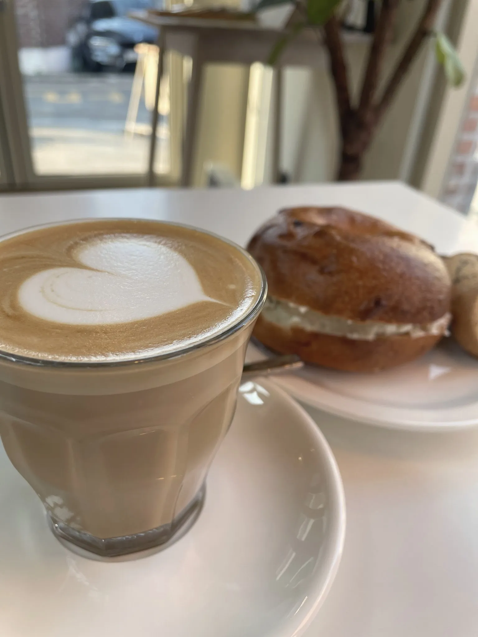 A flat white and pastry on a Seoul cafe table