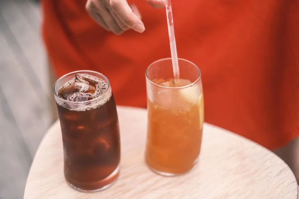 Iced drinks on an orange cafe table