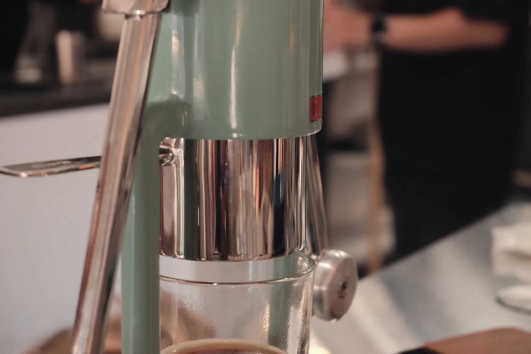 A lever espresso machine mid-brew
