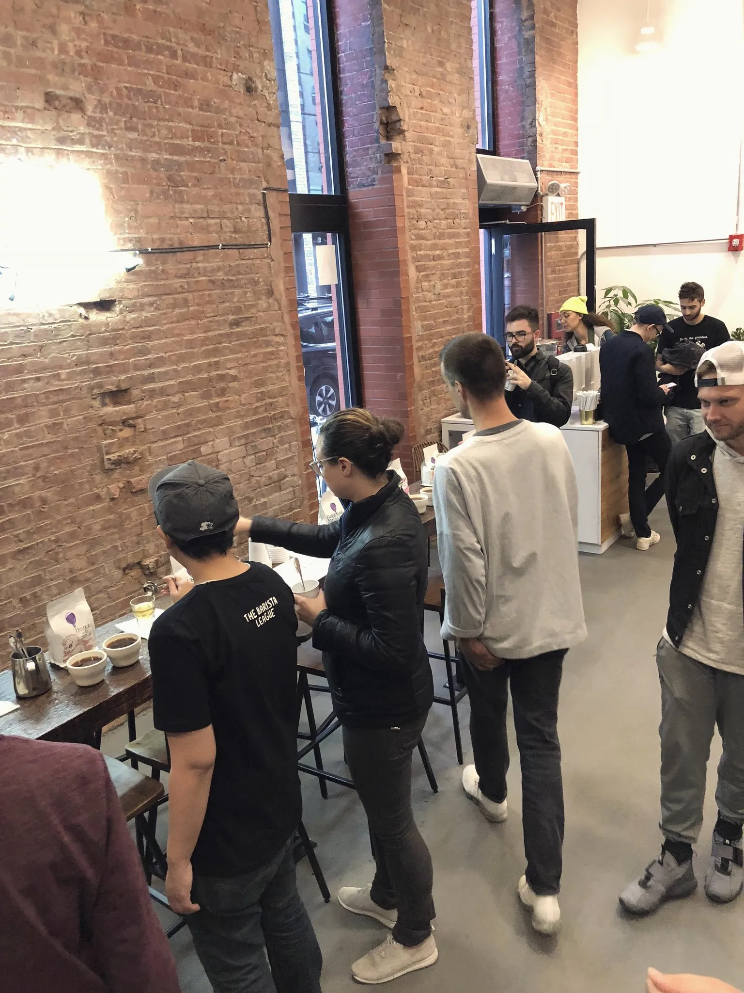 Pouring hot water over coffee grounds during a cupping