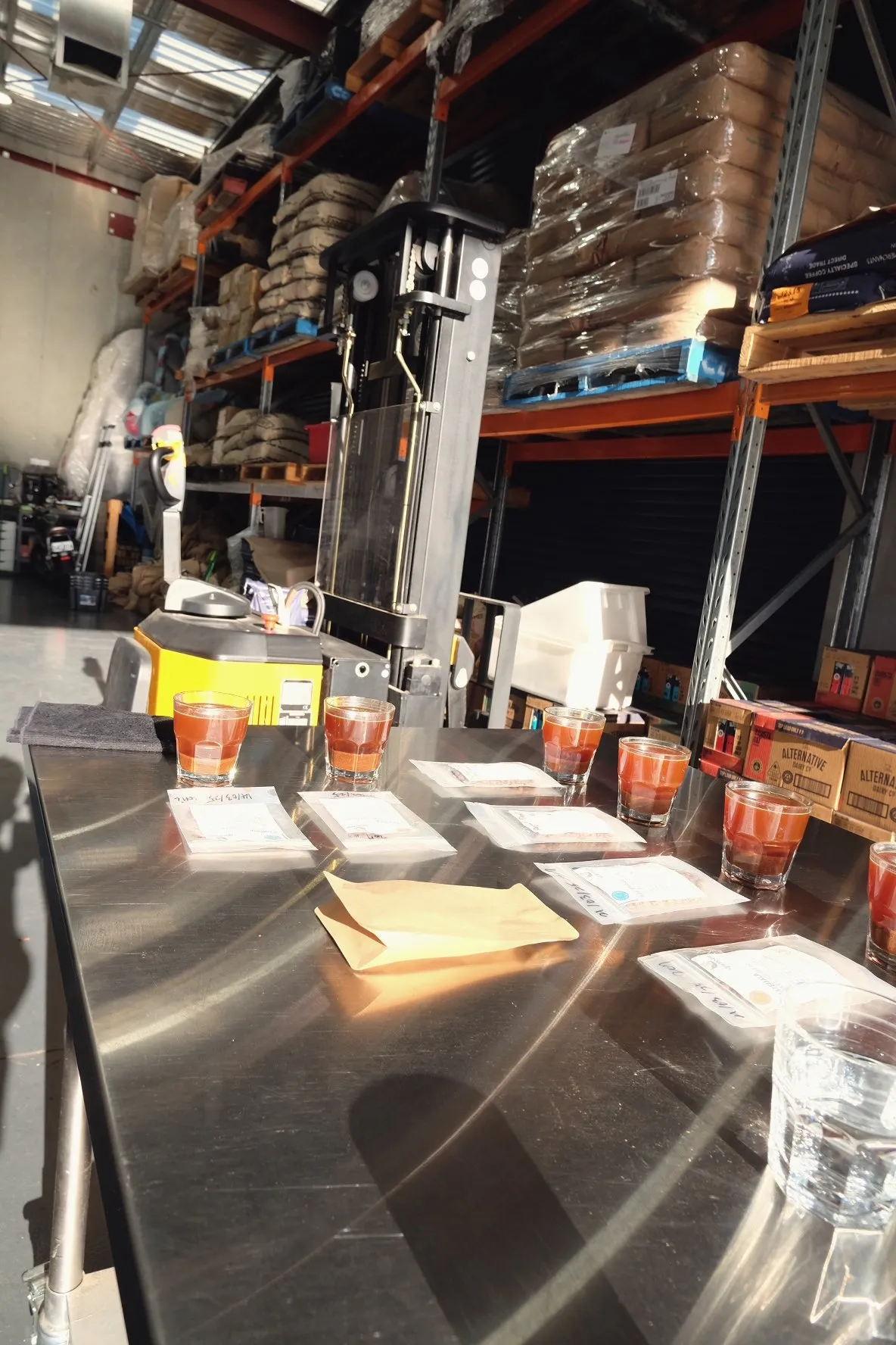 A long cupping table inside a roastery