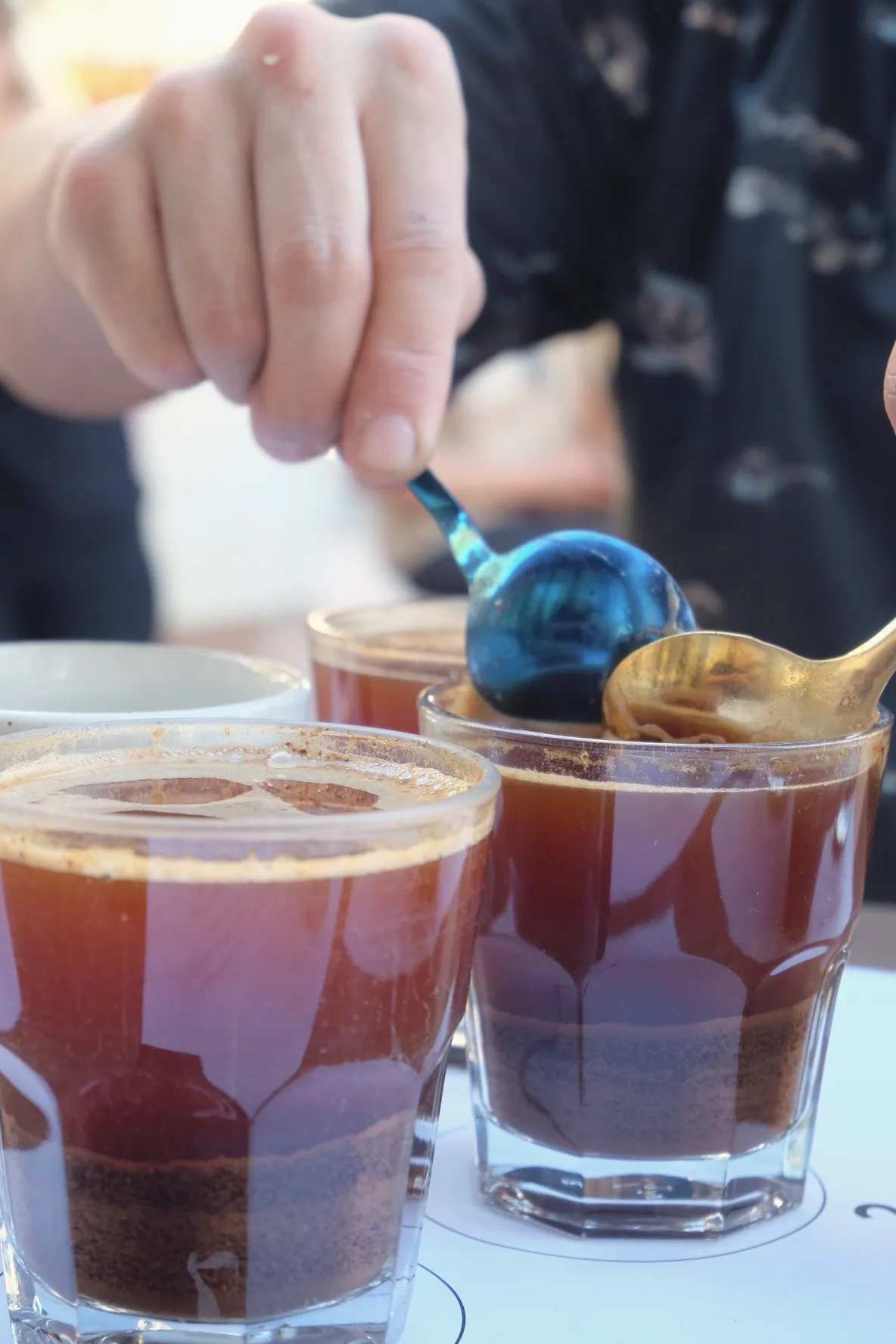 Rows of cupping glasses set on an outdoor table