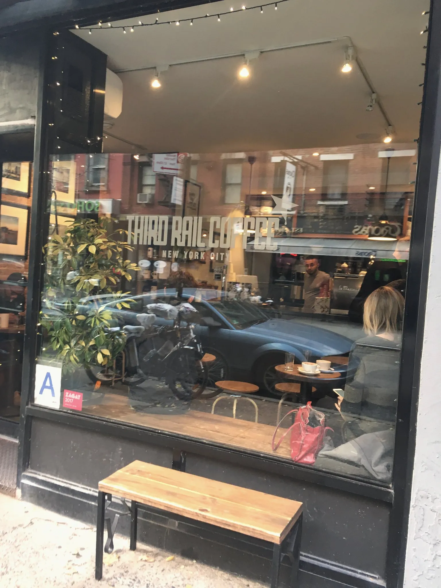 Brick storefront of a coffee shop on a West Village corner in New York